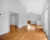 Additional living space with high vaulted ceiling and light hardwood / wood-style flooring