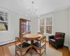 Dining space featuring baseboard heating, ornamental molding, light hardwood / wood-style flooring, and a notable chandelier