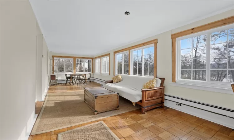 Sunroom featuring a healthy amount of sunlight and a baseboard radiator