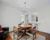 Dining room with a notable chandelier, ornamental molding, and hardwood / wood-style floors