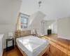 Bedroom featuring hardwood / wood-style flooring and lofted ceiling