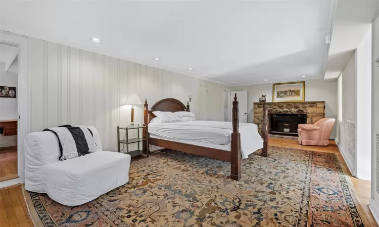 Lower Level Bedroom with ornamental molding and hardwood / wood-style flooring