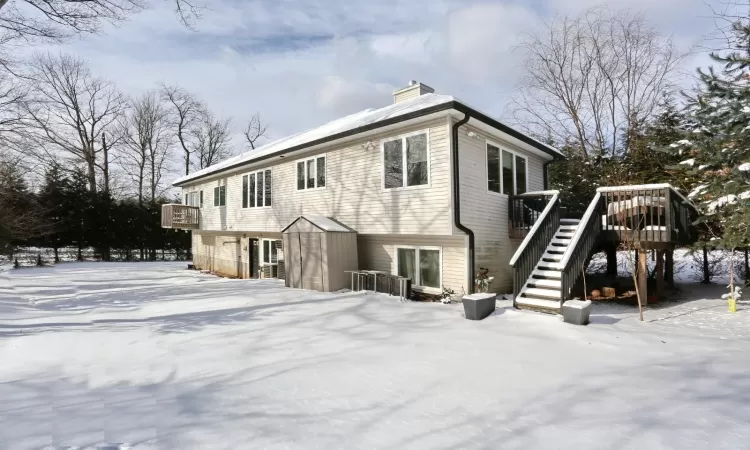 View of back of house featuring a wooden deck