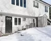 Snow covered house featuring cooling unit