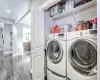 Laundry room featuring dark wood-type flooring and independent washer and dryer