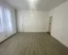 Living room featuring a wealth of natural light, wood-type flooring, and baseboard heating