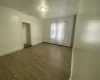 Living room featuring hardwood / wood-style flooring and a baseboard heating unit