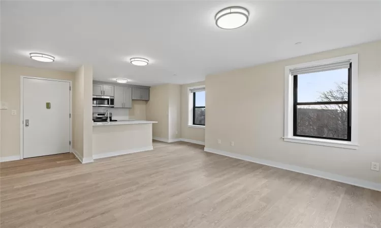 Unfurnished living room featuring light wood-type flooring