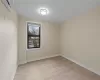 Empty room featuring a wall unit AC and light hardwood / wood-style flooring