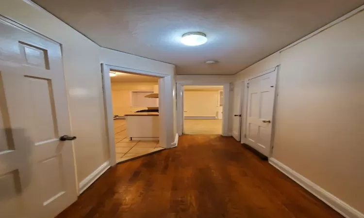 Hall with hardwood / wood-style flooring