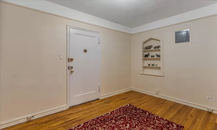 Entrance foyer with hardwood / wood-style floors