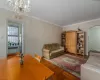 Living room featuring parquet floors and radiator heating unit