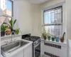 Kitchen with white cabinets, a wealth of natural light, sink, and stainless steel gas stove