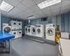 Laundry area featuring stacked washing maching and dryer, separate washer and dryer, and sink