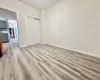 Unfurnished bedroom with ornamental molding, light hardwood / wood-style flooring, and a closet