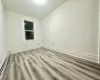 Spare room with a baseboard heating unit and light hardwood / wood-style floors