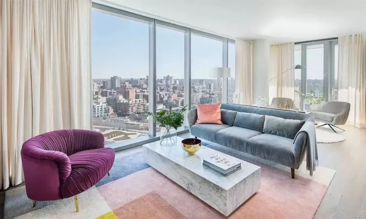 Living room featuring floor to ceiling windows and wood-type flooring