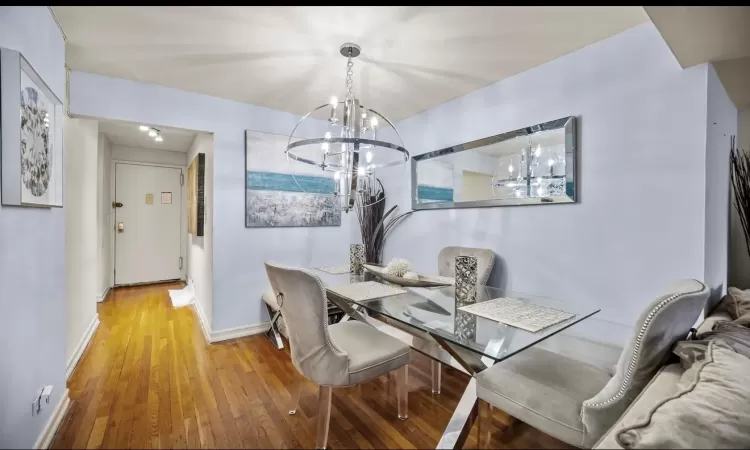 Dining space with a chandelier and hardwood / wood-style floors