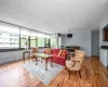 Living room featuring a baseboard radiator, a chandelier, and light wood-type flooring