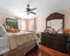 Bedroom with dark hardwood / wood-style floors and ceiling fan