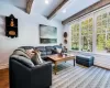 Living room with hardwood / wood-style floors and beam ceiling