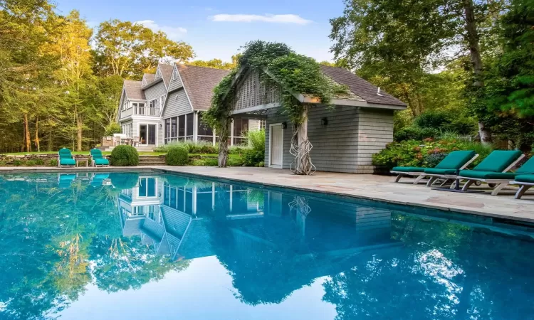 View of swimming pool with a patio area and a sunroom