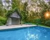 View of pool featuring an outbuilding and a patio area