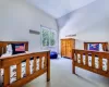 Bedroom featuring lofted ceiling and light carpet