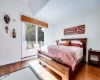 Bedroom featuring hardwood / wood-style flooring and access to exterior