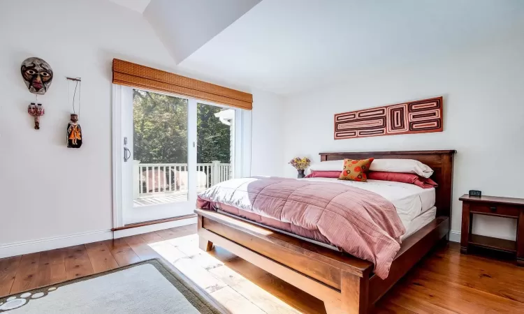 Bedroom featuring hardwood / wood-style flooring and access to exterior