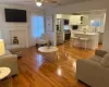 Living room featuring sink, ceiling fan, and light hardwood / wood-style flooring