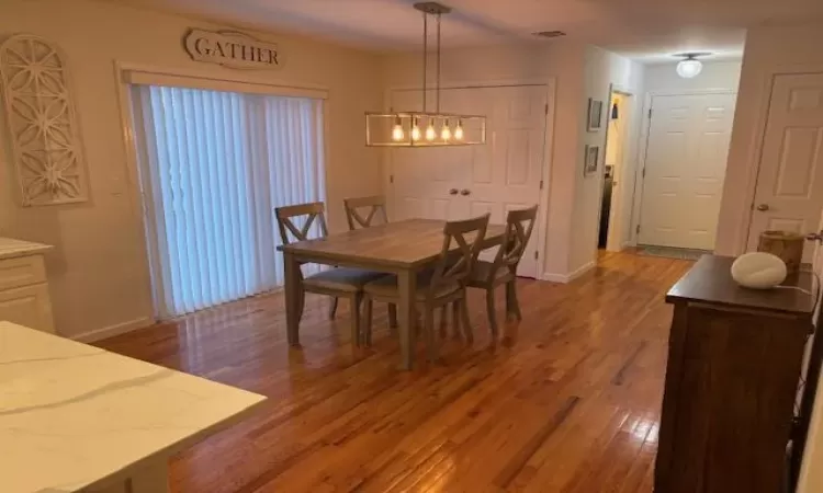 Dining room with dark wood-type flooring