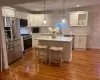 Kitchen with white cabinetry, stainless steel appliances, and a center island