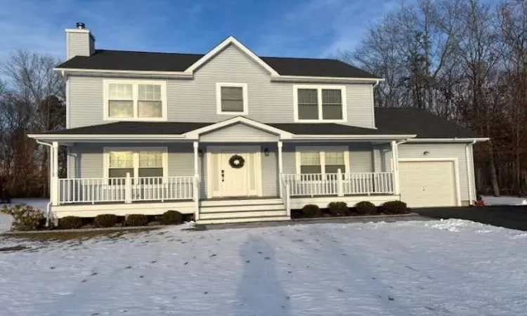 View of front of house featuring a porch and a garage