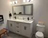 Bathroom featuring vanity, wood-type flooring, and toilet