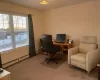 Home office featuring carpet flooring and a baseboard heating unit