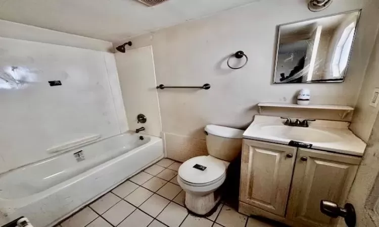 Full bathroom with vanity, tile patterned floors, shower / bathtub combination, and toilet