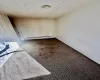 Unfurnished room with carpet flooring and baseboard heating