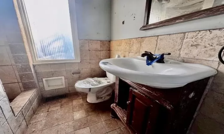 Bathroom featuring vanity and toilet