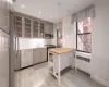 Kitchen featuring pendant lighting, butcher block countertops, radiator, sink, and stainless steel appliances