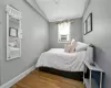 Bedroom featuring wood-type flooring and vaulted ceiling