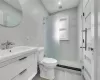 Bathroom with vanity, toilet, and walk in shower