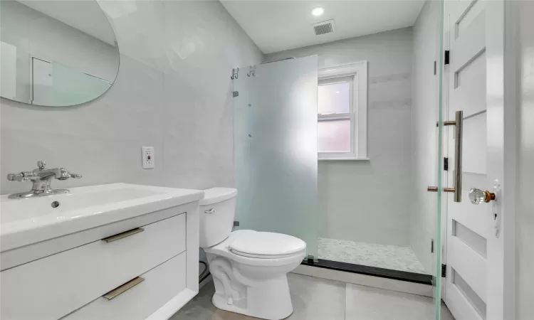 Bathroom with vanity, toilet, and walk in shower