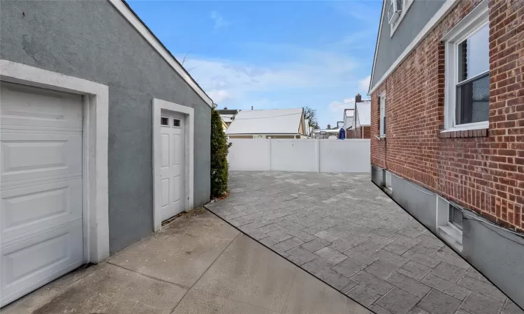 View of patio featuring a garage