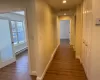 Hall with dark wood-type flooring and a baseboard heating unit