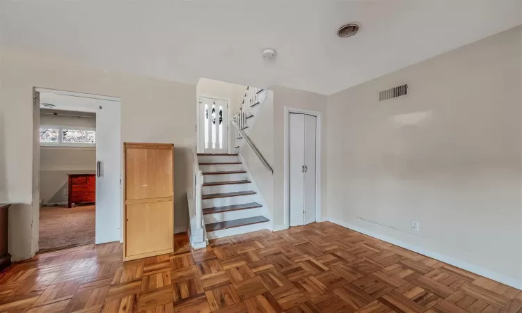 Stairway with a wealth of natural light and parquet floors