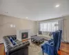 Living room featuring a baseboard radiator, hardwood / wood-style floors, and a fireplace