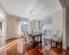 Dining area with an inviting chandelier, dark hardwood / wood-style flooring, and a baseboard radiator