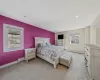 Carpeted bedroom featuring a baseboard heating unit