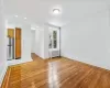 Unfurnished living room with radiator and light hardwood / wood-style floors